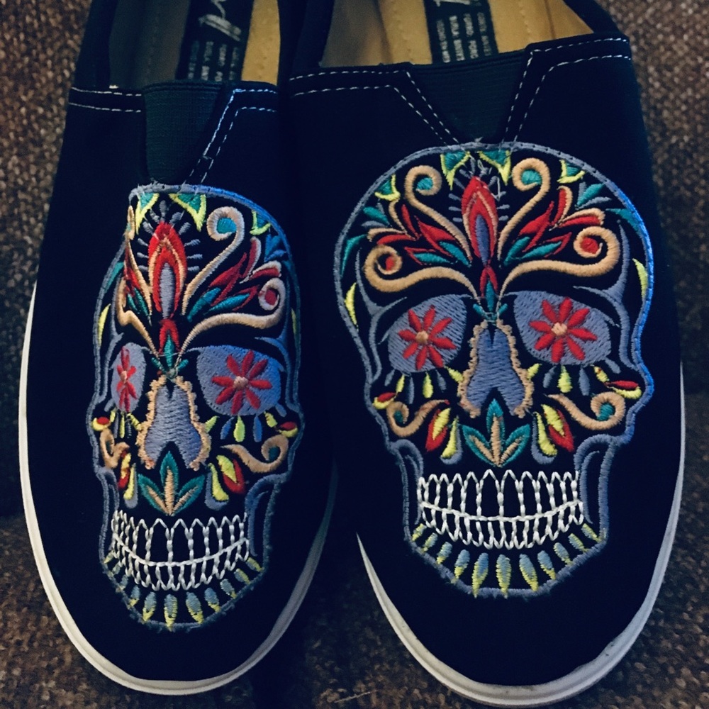 Sugar skull slip on embroidered sneakers.